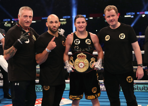 Katie Taylor celebrates with the belt and Ross Enamait