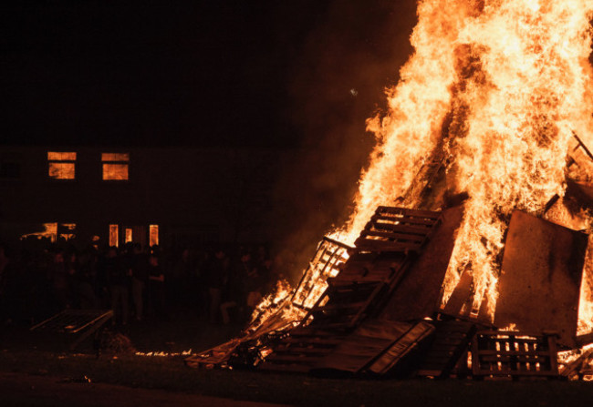 A house reflects the bonfire that is raging in front on Halloween night in Dublin