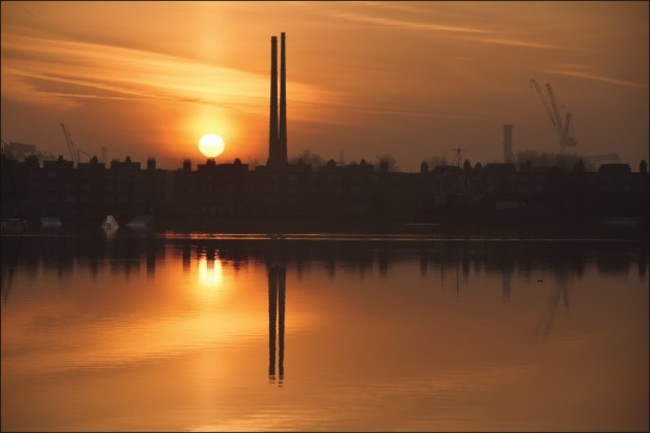 Poolbeg Chimney's silhouetted by sunrise