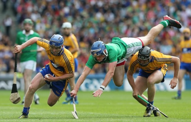 Gavin O'Mahony tries to tackle Padraic Collins and is upended by Colin Ryan