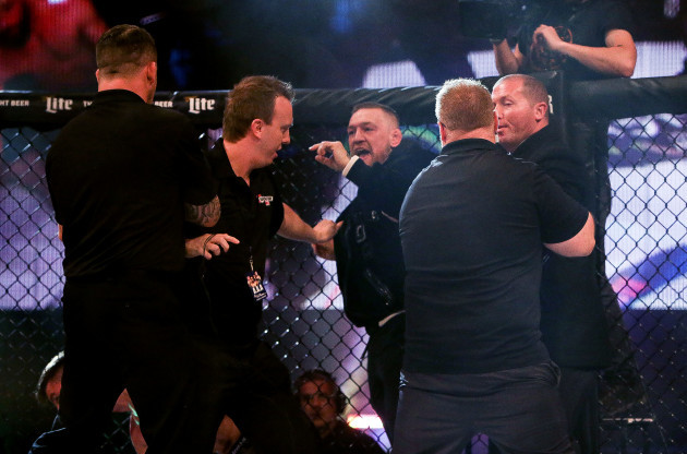 Conor McGregor is involved in a scuffle after the fight with referee Marc Goddard