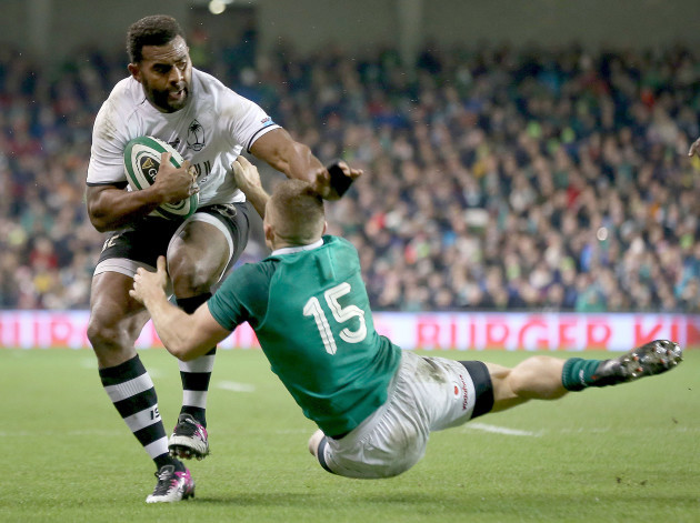Timoci Nagusa is tackled by  Andrew Conway