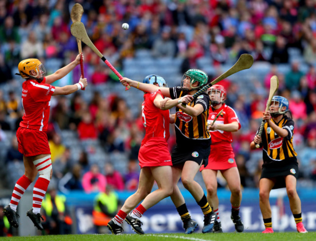 Aoife Murray clears the sliotar despite Miriam Walsh