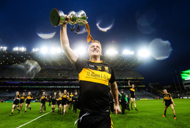 Johnny Buckley celebrates with the trophy after the game