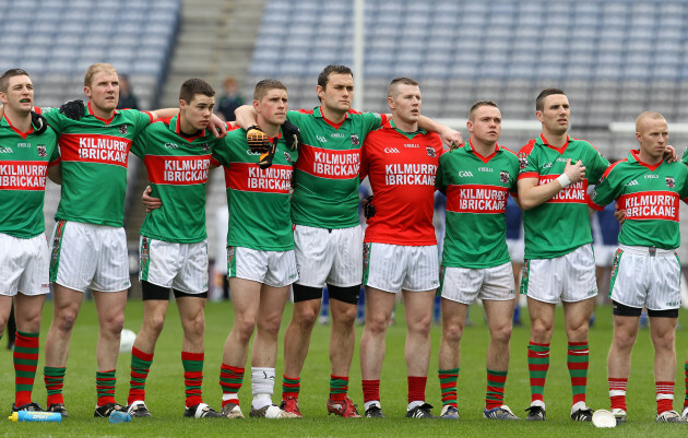 Kilmurry-Ibrickane players stand for the national anthem