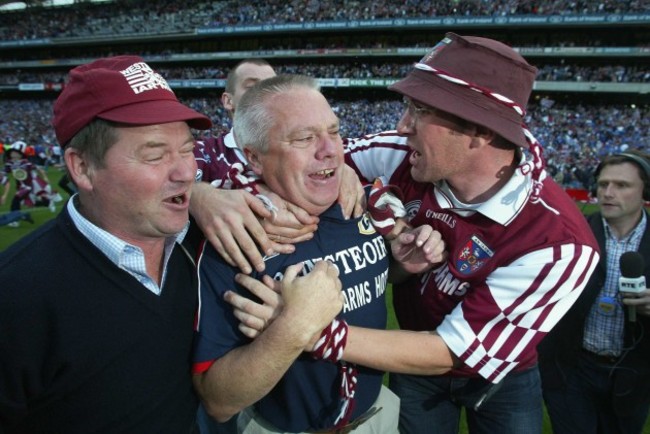 Paidi O'Se is engulfed by supporters at the end of the game