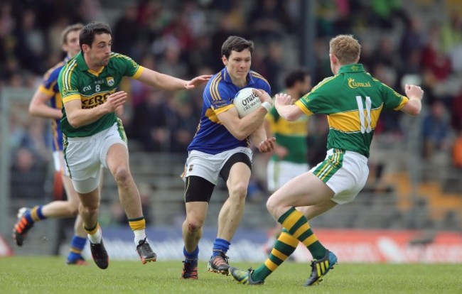 Anthony Maher and Colm Cooper tackle Ciaran McDonald