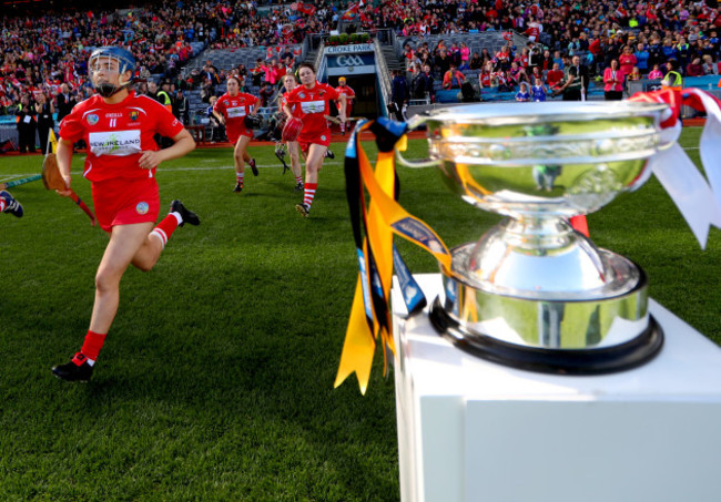 Orla Cronin and Chloe Sigerson run pass the O’Duffy Cup