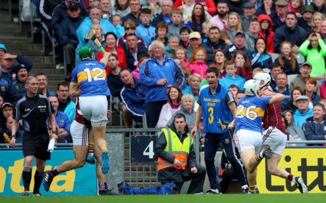 Joe Canning scores the winning point despite Noel McGrath and Niall O'Meara