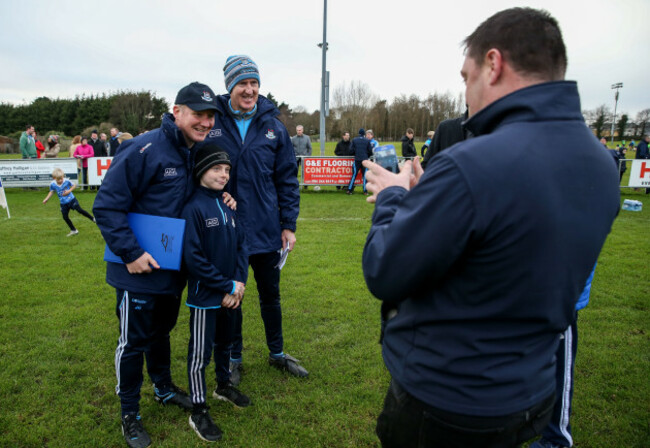 Jim Gavin and Paul Clarke pose for a photo with a young fan