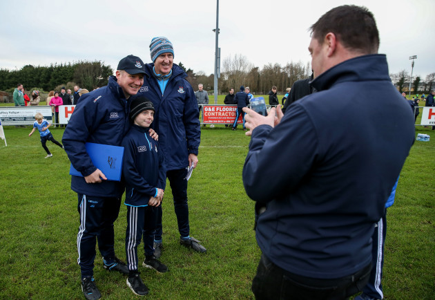Jim Gavin and Paul Clarke pose for a photo with a young fan
