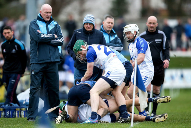 Players from both sides scuffle as Dublin manager Pat Gilroy looks on