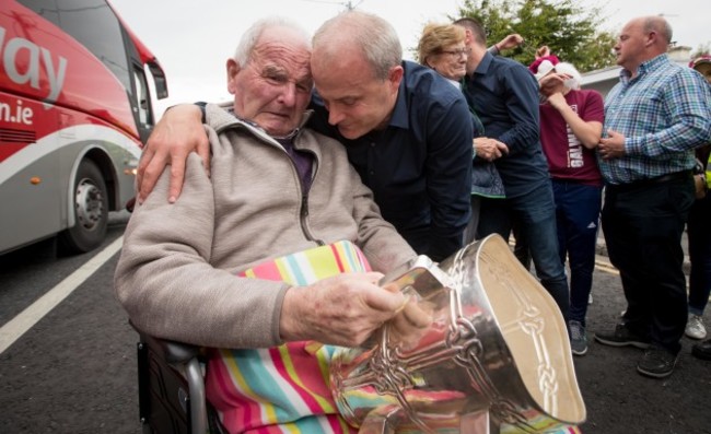 Micheal Donoghue shows the Liam McCarthy to his father Miko Donoghue for the first time