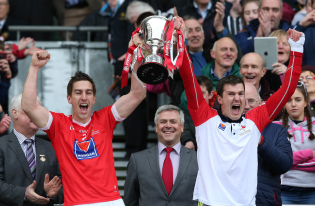 Padraig Rath and Adrian Reid lift the cup