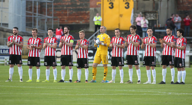 Derry players during the minute's applause in memory of Bishop Edward Daly