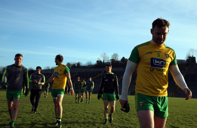 Donegal players leave the pitch after the game is postponed