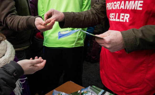 A spectator returns his programme for his euro back