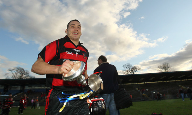 Shane O'Sullivan heads for the dressing room with the trophy after the game