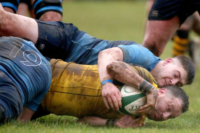 Donal Crotty scores a try despite the efforts of Keith Burke