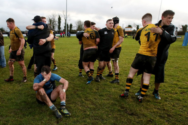 Ciaran Lowry dejected at the end of the game while Ashbourne players celebrate around him