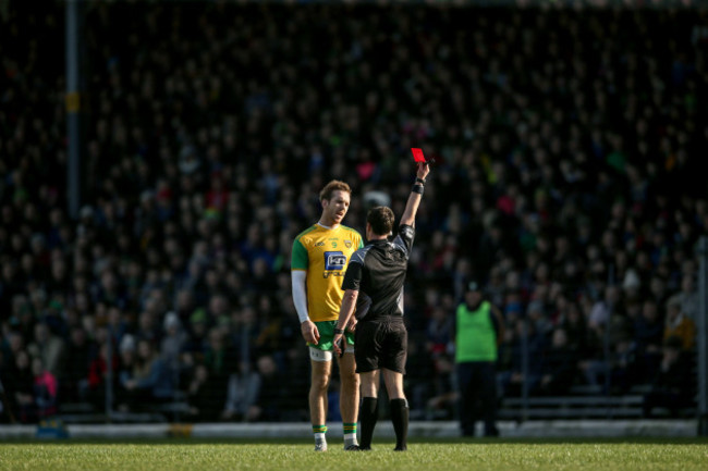 Paddy Neilan shows Nathan Mullins a red card