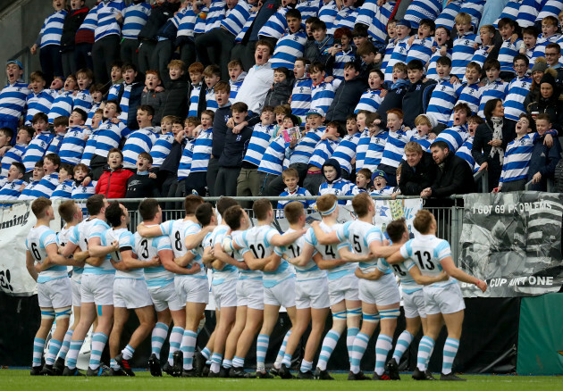 Blackrock College players greet the fans as they enter the pitch