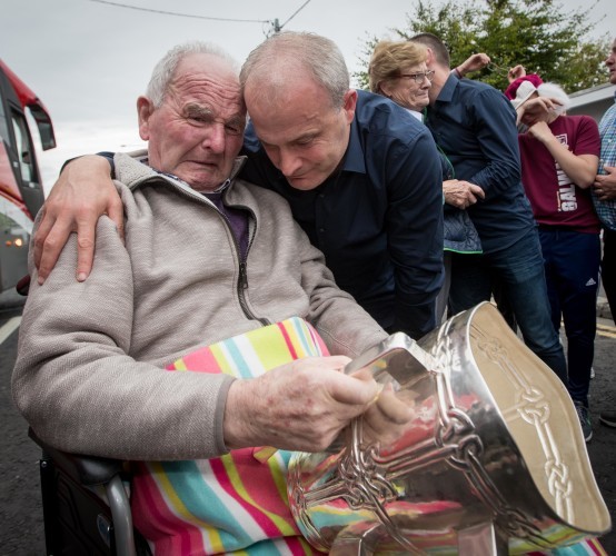 Micheal Donoghue shows the Liam McCarthy to his father Miko Donoghue for the first time