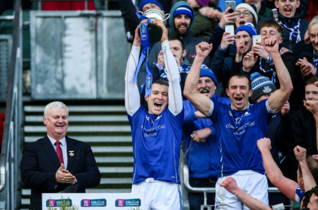 Declan Prendergast and Seamus Prendergast lift the trophy
