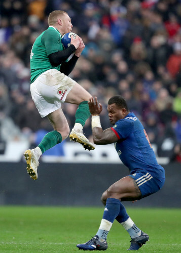 Keith Earls collects a cross field kick from Jonathan Sexton despite the efforts of Virimi Vakatawa