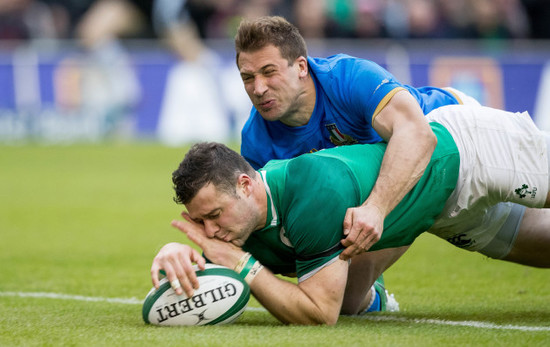 Robbie Henshaw scores their fifth try despite the efforts of Tommaso Benvenuti