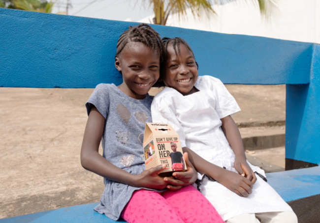 Kumba (7) is pictured with her younger sister Fatu (5) as they see their image on this year’s Trócaire box for the first time.
