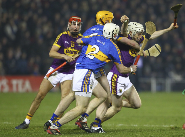 Wexford's David Dunne is tackled by Tipperary's Padraic Maher