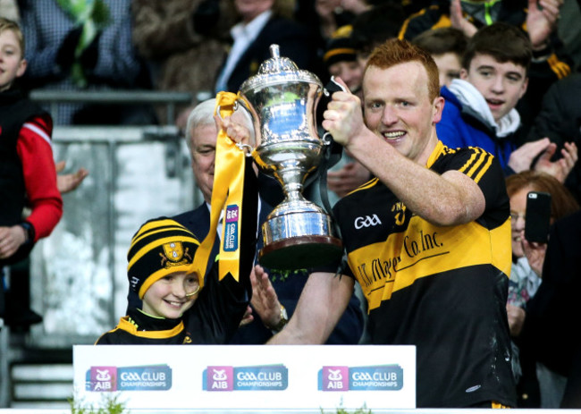 Johnny Buckley lifts the trophy with Amy O'Connor