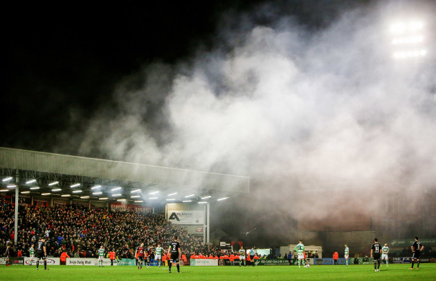 Smoke covers the pitch after fans let off flares