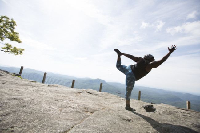 Mirna practicing yoga on the top of Whiteside Mountain, North Carolina.