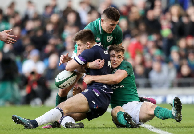 Jacob Stockdale and Garry Ringrose tackle Huw Jones