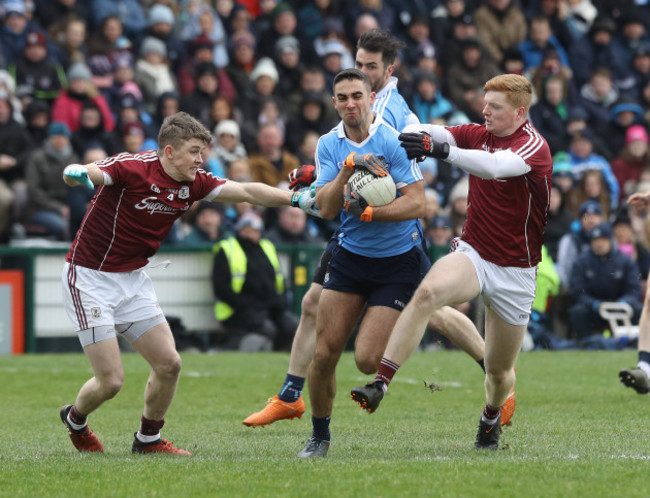 Sean Andy O'Ceallaigh and David Wynne tackle James McCarthy