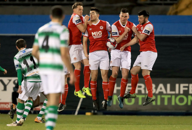 The St. Patrick's Athletic wall blocks a free kick from Sean Kavanagh