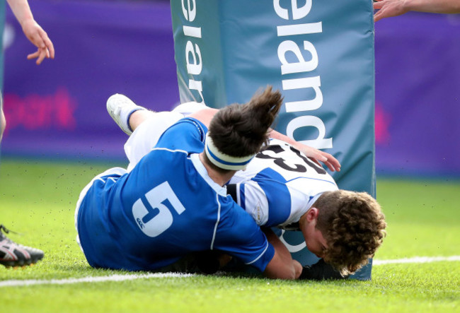 Tom Henderson scores his sides first try despite the efforts of Hugo Massey