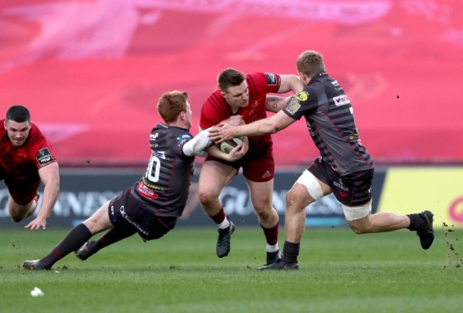 Rory Scannell is tackled by Rhys Patchell and James Davies