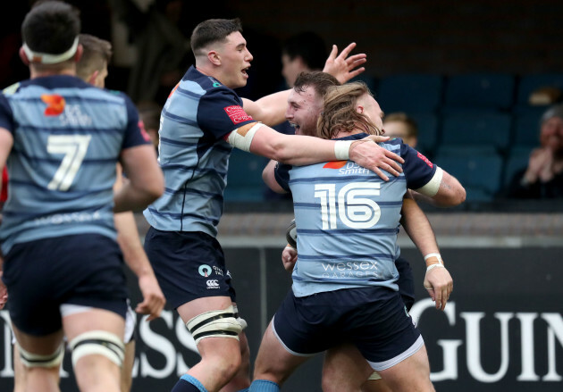 Dillon Lewis celebrates his bonus point try with teammates