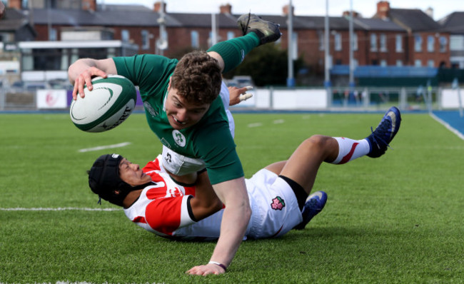 Hugh Lane scores a try despite the efforts from Seung Sin Lee