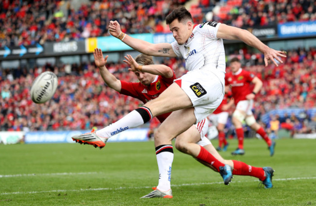 Jacob Stockdale clears the ball under pressure from Angus Lloyd