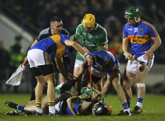 Players and officials surround Donagh Maher and Graeme Mulcahy