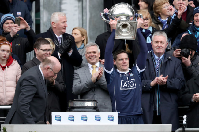 Stephen Cluxton receives the trophy from John Horan