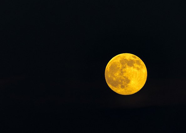 Beautiful yellow full solstice moon on a clear star less