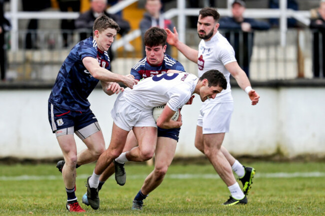 Eanna O'Connor tackled by David Wynne and Sean Kelly