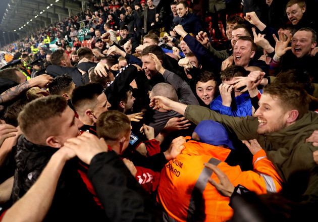 Darragh Leahy celebrates scoring their second goal with fans and his teammates