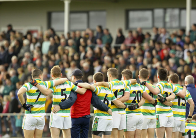 Players of Carbery Rangers stand for the national anthem before the game