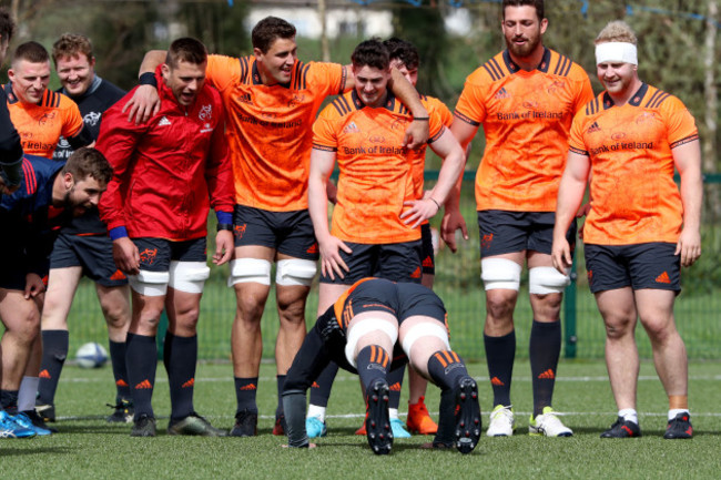 Peter O'Mahony does press-ups while his teammates watch on after he is late for training